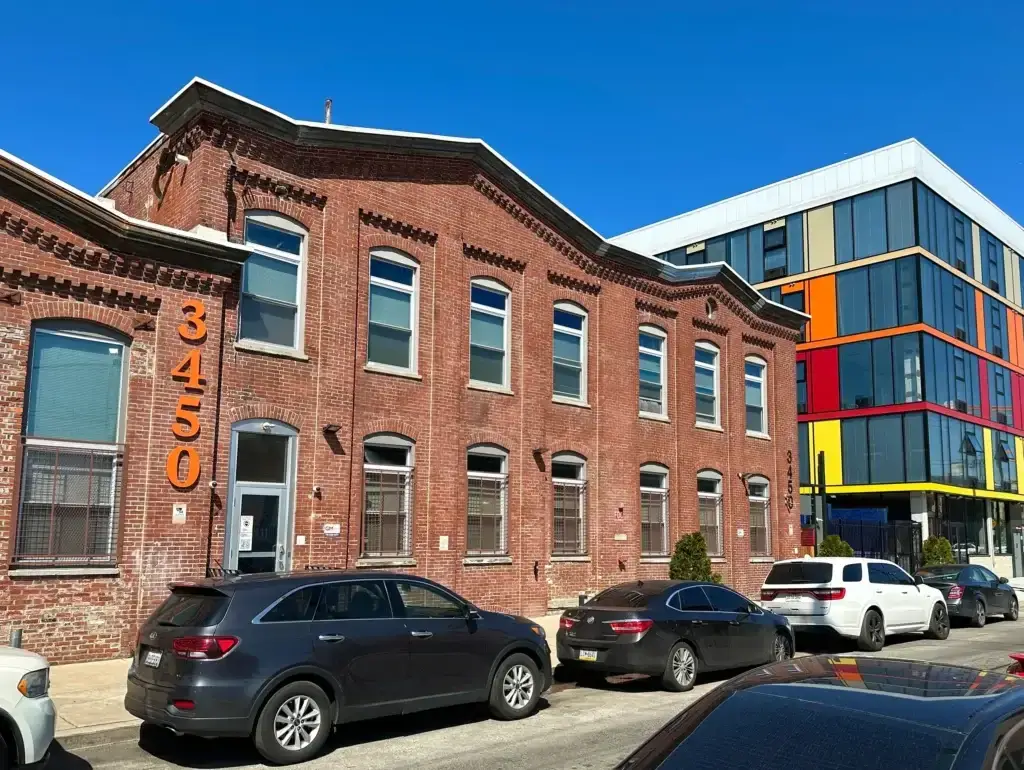 3450 J Street luxury apartments show a brick facade with ornate brickwork and arched windows in Philadelphia PA