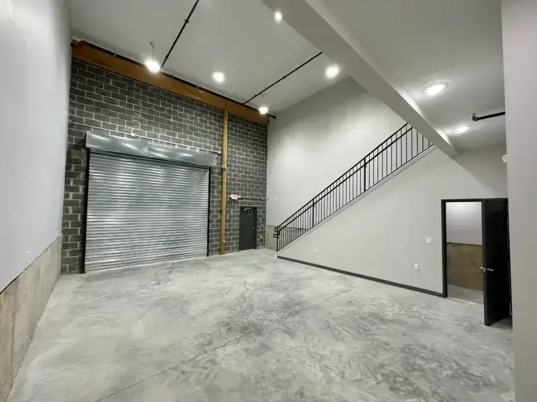 Garage door view with stairs leading upstairs to the commercial office space at 3001 Ormes Street