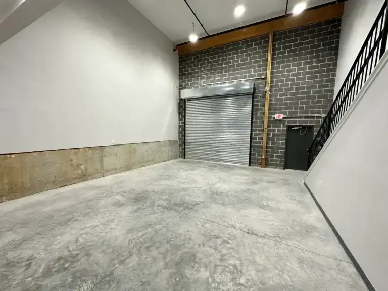 Garage door view with stairs leading upstairs to the commercial office space at 3001 Ormes Street