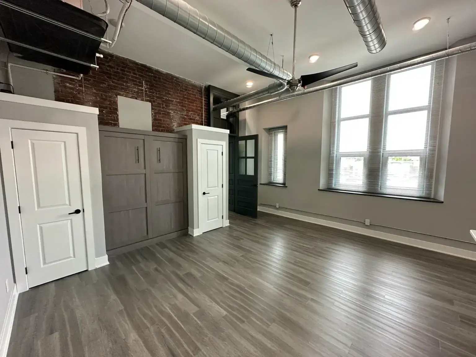 3701 Frankford Ave Unit 202 living area showing high ceilings natural window light and wood flooring